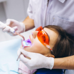 A dentist offering a laser teeth whitening treatment