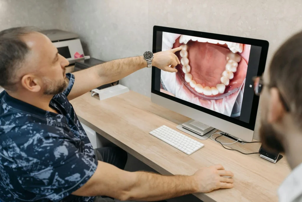 Dentist discussing crooked teeth treatment in Dubai using clear aligners