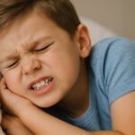 Child grinding teeth while sleeping in bed