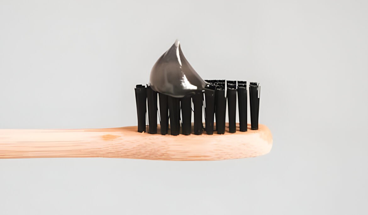 Toothbrush with black bristles and activated charcoal toothpaste
