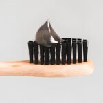 Toothbrush with black bristles and activated charcoal toothpaste