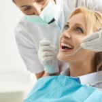 whitening Teeth doctor treating teeth of a beautiful woman