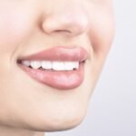 Smiling female face with beautiful, even and white teeth